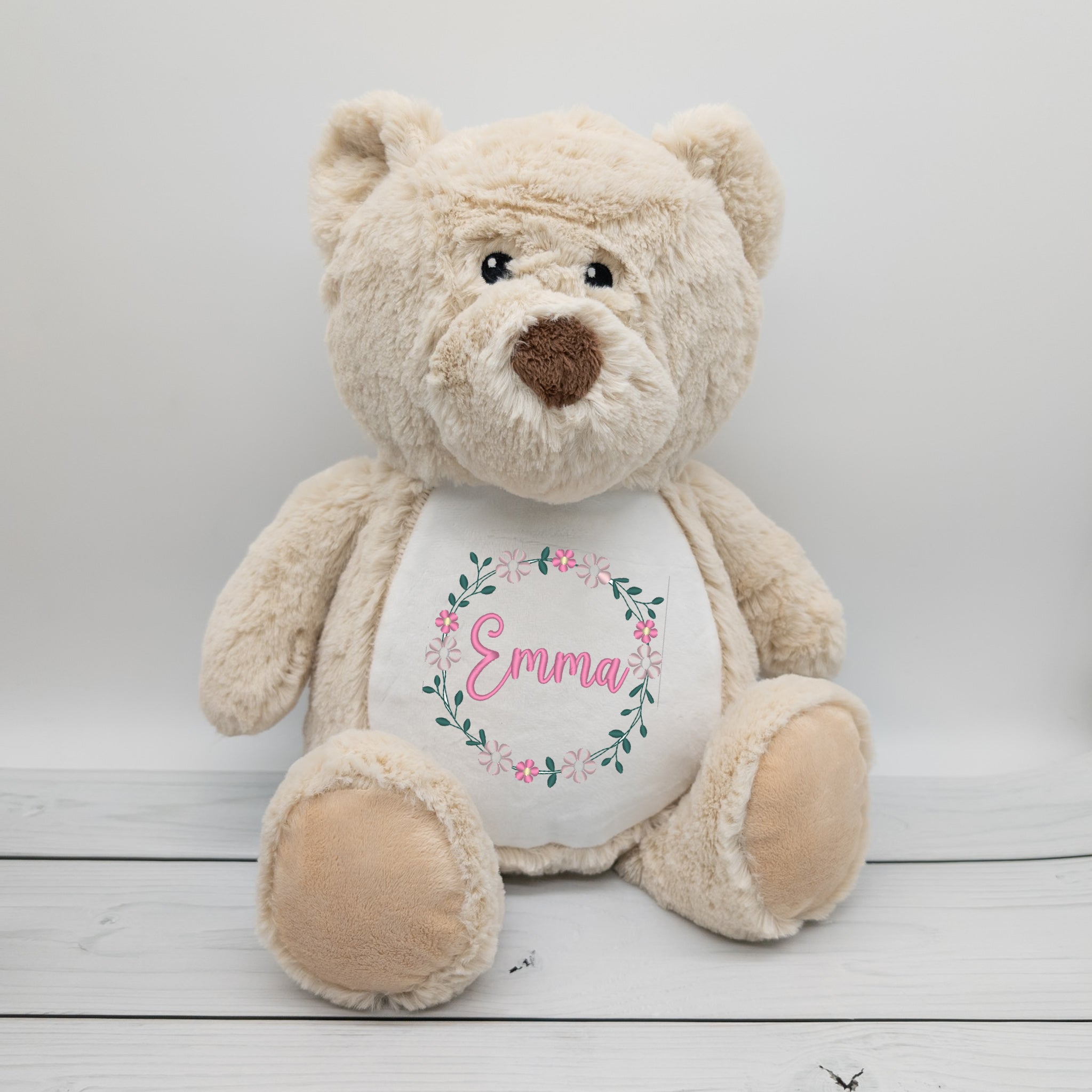 Kuscheltier Bär mit Blumenkranz und Namen bestickt